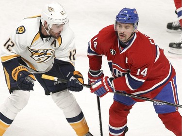 Montreal Canadiens Tomas Plekanec, right, grabs Nashville Predators Mike Fisher's stick during first period of National Hockey League game in Montreal Tuesday January 20, 2015.