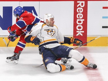 Nashville Predators Eric Nystrom loses his stick after check by Montreal Canadiens Christian Thomas during second period of National Hockey League game in Montreal Tuesday January 20, 2015.