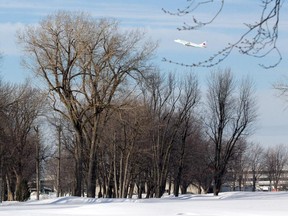 A jet takes off from Pierre Elliott Trudeau International Airport in the Dorval area of Montreal Thursday, January 22, 2015 seen from the Club de Golf Municipal Dorval. Aéroports de Montréal  will not renew the municipal golf course's lease at the end of 2015. They say they need the land for rails for the Train de l'Ouest.