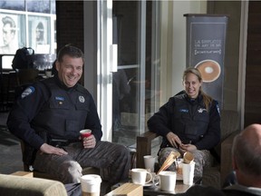 Officers Giovanni Di Legge and Melanie Allard from SPVM station 1 Montreal, have a coffee at the local Starbucks and chat with residents January 22, 2015.