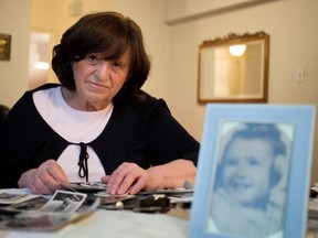 Family pictures from the early 1940s surround Angela Richt at her kitchen table in Montreal on Saturday January 24, 2015.  Her birth certificate lists her place of birth as Auschwitz. Richt was one of the very few Jewish children to survive after being born inside the Birkenau concentration camp. Richt is about 4 years old in the photograph at right.