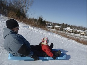 Leonardo Riveraand his daughter Malei take a ride down the toboggan run at Centennial Park in  Dollard-des-Ormeaux Sunday, January 25, 2015.