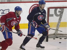 Montreal Canadiens Sergei Gonchar, right, sticks near the net with teammate Montreal Canadiens' Alex Galchenyuk during practice Jan. 26, 2015.