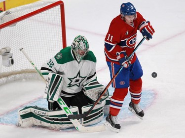 Brendan Gallagher of the Montreal Canadiens is hit by a shot as he stands in front of the Dallas Stars goalie Kari Lehtonen in the third period of an NHL game at the Bell Centre in Montreal Tuesday, January 27, 2015.