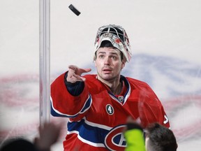 Carey Price of the Montreal Canadiens tosses a puck to fans after being named the first star of an NHL game at the Bell Centre in Montreal Tuesday, January 27, 2015 against the Dallas Stars.