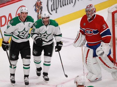 Dallas Stars players Jamie Benn (left) and Patrick Eaves celebrate the team's second goal as Carey Price of the Montreal Canadiens looks over in the second period of an NHL game at the Bell Centre in Montreal Tuesday, January 27, 2015.