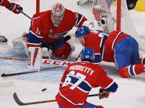 Defenceman Alexei Emelin (right) of the Montreal Canadiens helps goalie Carey Price stop a puck in front of the net in the first period against the Dallas Stars in an NHL game at the Bell Centre in Montreal Tuesday, January 27, 2015.