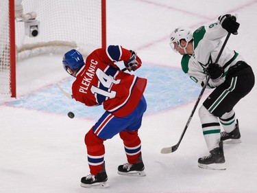 Tomas Plekanec of the Montreal Canadiens misses the empty net after goalie Kari Lehtonen of the Dallas Stars had been pulled for an extra attacker in the third period of an NHL game at the Bell Centre in Montreal Tuesday, January 27, 2015. Defending is Jason Spezza.