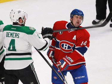 Tomas Plekanec of the Montreal Canadiens takes a high stick from Jason Demers of the Dallas Stars in the third period of an NHL game at the Bell Centre in Montreal Tuesday, January 27, 2015.