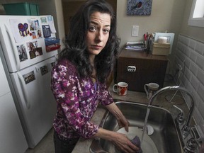 Anick Boivin does the dishes in her home in Pointe-Claire, west of  Montreal Thursday January 29, 2015.  Her attempt to go back to school and get off public assistance was thwarted when Emploi-Québec informed her that her welfare cheques would be cut off.