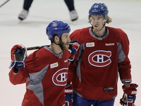 Forwards Brandon Prust (left) and Dale Weise talk during practice at the Bell Sports Complex in Brossard on Jan. 30, 2015.