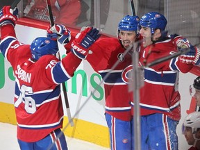 Montreal Canadiens' Max Pacioretty, right, celebrates his game winning goal against the Washington Capitals, with teammates Tomas Plekanec, centre, and P.K. Subban during overtime period NHL action in Montreal on Saturday, January 31, 2015.