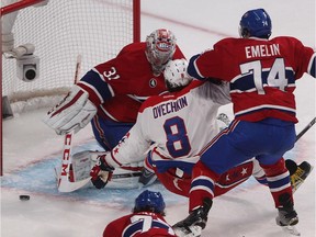 Washington Capitals' Alex Ovechkin is pushed to the ice by Montreal Canadiens' Alexei Emelin in front of Montreal Canadiens goalie Carey Price during second period NHL action in Montreal on Saturday January 31, 2015.