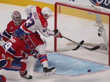 Washington Capitals' Jay Beagle tries to put puck past Montreal Canadiens goalie Carey Price, while Montreal Canadiens' Andrei Markov, comes in from behind, during first period NHL action in Montreal on Saturday, January 31, 2015.