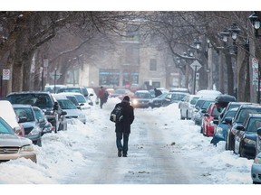 MONTREAL, QUE.: JANUARY 5, 2015 -- A man walks on ice down Henri-Julien avenue near the corner of Jean-Talon street in Montreal on Monday, January 5, 2015. Montreal and other regions of Quebec were hit with an ice storm on Sunday. (Dario Ayala / Montreal Gazette)