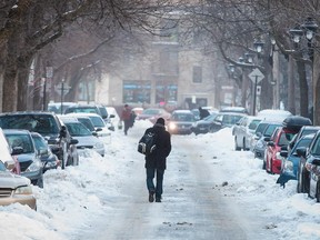 A man walks on ice down Henri-Julien avenue near the corner of Jean-Talon street in Montreal Monday, January 5, 2015.