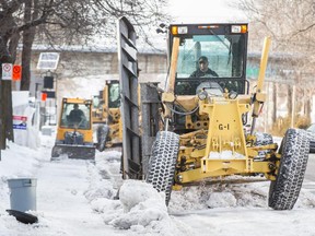 A snow-clearing operation removes the ice on Berri street near the corner of Louvain street in the neighbourhood of Ahuntsic in Montreal on Monday, January 5, 2015.
