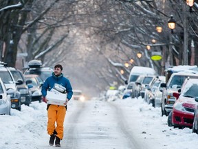 Julian Grumbach, visiting from Germany, walks in the middle of the street to avoid icy sidewalks near the corner of Casgrain avenue and Castelnau street in Montreal on Monday, January 5, 2015. Montreal and other regions of Quebec were hit with an ice storm on Sunday.