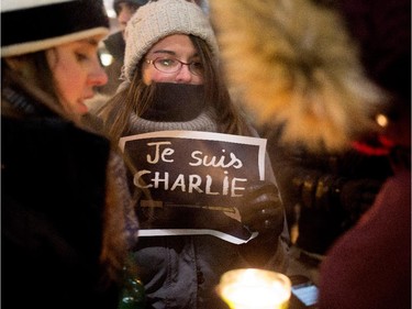 A group of women brave the -23C temperatures to participate in a candle light vigil outside the French Consulate in Montreal on Wednesday January 7, 2015. Montrealers gathered in support of the victims of the terrorist attack on Charlie Hebdo in Paris earlier today that left 12 people dead and 11 injured.