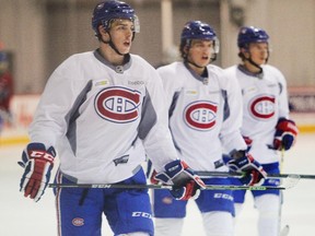 Young Canadiens forwards (from left) Michaël Bournival, Sven Andrighetto and Christian Thomas take a breather after a sprint during practice at the Bell Sports Complex in Brossard on Jan. 9, 2015.
