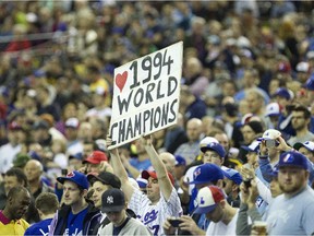 Expos fans salute members of the 1994 team during a pre-game ceremony before exhibiton game between the Toronto Blue Jays and New York Mets at Montreal's Olympic Stadium on March 29, 2014.