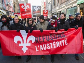 People take part in an anti-austerity protest in downtown Montreal on Saturday, November 29, 2014.