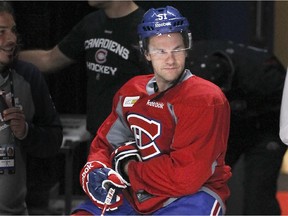 Canadiens forward David Desharnais sits on the edge of the boards during practice at the Bell Centre in Montreal on Oct. 20, 2014.