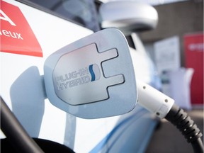 A Toyota Prius hybrid is plugged in for charging during a test drive session for the EV 2012 Electric Vehicle trade show at Circuit Gilles Villeneuve in Montreal in October 2012.