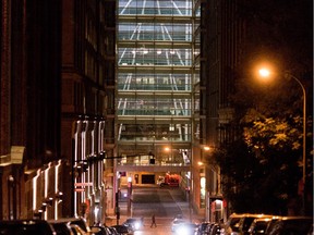 A nighttime view of the glass hallways and atrium at Caisse de Depot et Placement du Quebec building in Montreal (2014).