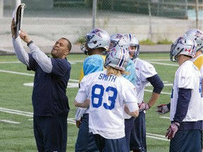 Alouettes defensive quality-control coach  Anwar Stewart reviews a play during practice on Sept. 18, 2014.