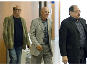 Former FTQ union boss Jocelyn Dupuis, centre, at the Montreal courthouse, Friday, September 26, 2014, where he was found guilty by a Quebec court judge on all charges of fraud and forging documents related to expense claims.