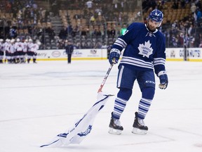 Toronto forward Nazem Kadri picks up a Maple Leafs jersey thrown onto the ice after a 6-2 loss to the Washington Capitals on Jan. 7 in Toronto.