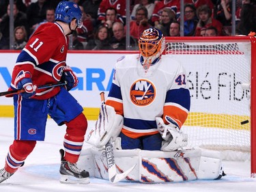 The puck goes past Jaroslav Halak of the New York Islanders on a shot by Tomas Plekanec (not pictured) of the Montreal Canadiens at the Bell Centre on Saturday, Jan. 17.