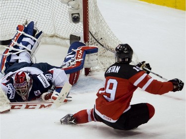 Canada forwarde Nic Petan (19) scores his second goal of the game past Slovakia goalie Denis Godla during second period semifinal hockey action at the IIHF World Junior Championships in Toronto on Sunday, January 4, 2015.