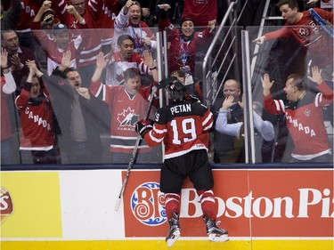 Canada forward Nic Petan celebrates his third goal of the game with Canada fans after scoring past Slovakia during third period semifinal hockey action at the IIHF World Junior Championships in Toronto on Sunday, January 4, 2015.
