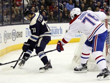 Columbus Blue Jackets' Nick Foligno, left, works for the puck against Montreal Canadiens' P.K. Subban during the second period of an NHL hockey game in Columbus, Ohio, Wednesday, Jan. 14, 2015.