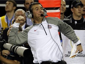 Ohio State head coach Urban Meyer celebrates on the sideline during second half of the NCAA college football playoff championship game against Oregon  on Jan. 12, 2015, in Arlington, Texas. Ohio State won 42-20.