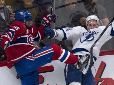 Montreal Canadiens' P.K. Subban and Tampa Bay Lightning's Ryan Callahan collide along the boards during second period NHL hockey action Tuesday, January 6, 2015 in Montreal.