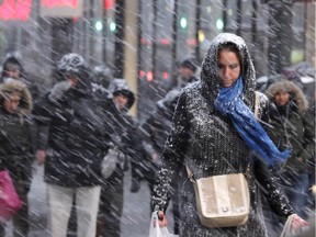 Pedestrians make their way through snow in New York, Monday, Jan. 26, 2015. More than 35 million people along the Philadelphia-to-Boston corridor rushed to get home and settle in Monday as a fearsome storm swirled in with the potential of 1 to 3 feet of snow that could paralyze the Northeast for days.