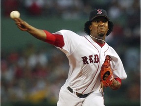 In this June 25, 2004 file photo, Red Sox pitcher Pedro Martinez delivers pitch during game against the Philadelphia Phillies at Fenway Park in Boston.
