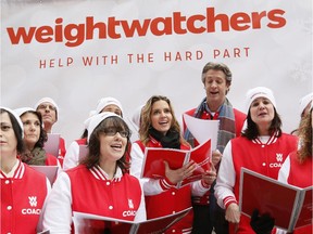 Viral video sensations Penn and Kim Holderness join the Weight Watchers Coaches Chorus in New York's Union Square on Dec. 17 to sing about the cravings and temptations familiar to the holiday season.