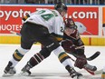 Michael McCarron of the London Knights takes faceoff against Josh Coyle of the Peterborough Petes during an OHL game at Budweiser Gardens on Dec. 14, 2014, in London, Ont.