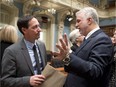Quebec Premier Philippe Couillard, right, and Quebec Opposition Leader Stephane Bedard chat after they exchanged season's greetings as the fall session comes to an end Friday, December 5, 2014 at the legislature in Quebec City. Bedard suggested last week  that the premier was slow to act on a Quebec charter of secularism because he had been “impregnated” by Saudi Arabian values.
