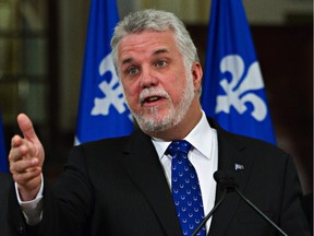 Quebec Premier Philippe Couillard says he is the victim of a smear campaign after a Montreal newspaper report that a former colleague of his has been accused of financial fraud.