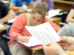 A social studies teacher reviews an assignment on June 10, 2012. in Picture Butte High School in Alberta.