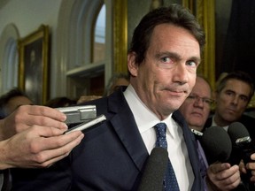 Quebec Opposition MNA Pierre-Karl Peladeau is surrounded by reporters as he arrives at a caucus meeting on Nov. 18, 2014.