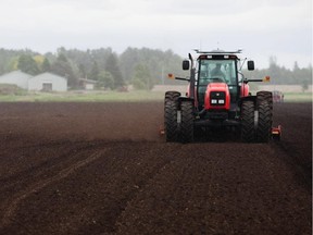 A tractor prepares the soil for a carrot field at the farm Les Jardins A. Guerin in Sherrington, 50 kilometres south of Montreal on Thursday, June 2, 2011. The farm produces radishes, carrots, and onions.