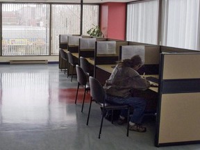 A man looks through jobs at a Resource Canada offices in Montreal April 9, 2009. A new study from the Human Resources Department suggests Ottawa is looking at ways to get people receiving employment insurance to move to other regions with more jobs.