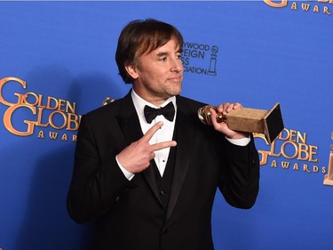 Richard Linklater poses in the press room with the award for best director for "Boyhood" at the 72nd annual Golden Globe Awards at the Beverly Hilton Hotel on Sunday, Jan. 11, 2015, in Beverly Hills, Calif.