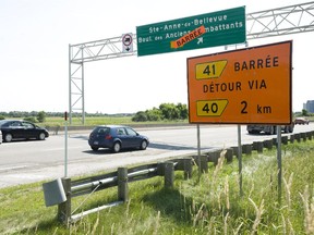 Signs at exit 41 on the 40 west highway is shown at Ste-Anne-de-Bellevue, Friday, July 8, 2011.